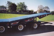J.C. 50 Ton sliding 4 axle folding tail trailer. Used for Machinery Movers. Able to load in or out of loading docks.