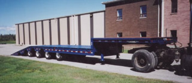 J.C. 50 Ton sliding 4 axle folding tail trailer. Used for Machinery Movers. Able to load in or out of loading docks.